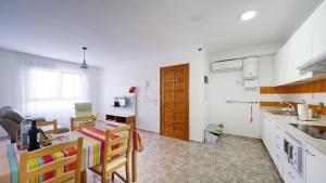 a kitchen with a table and some chairs in a room at Armonía Beach 17 in Arinaga