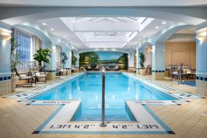 a large swimming pool in a hotel lobby at Fairmont Royal York Gold Experience in Toronto