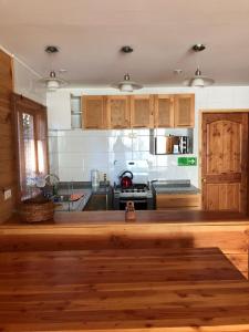 a kitchen with a wooden counter top in a room at Cabañas Borgolafquen in Panguipulli