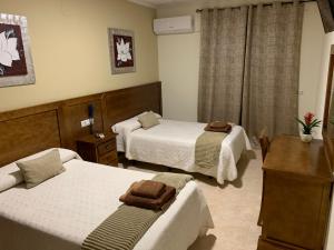 Postel nebo postele na pokoji v ubytování Hotel Don Juan