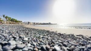a beach filled with lots of rocks and the ocean at Armonía Beach 17 in Arinaga