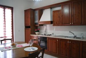 a kitchen with wooden cabinets and a wooden table at home paolina in Greve in Chianti