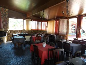 a dining room with tables and chairs with red table cloth at Villa Maria in Kalymnos