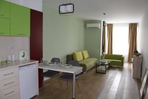 a kitchen and living room with a table and a couch at Hotel39 in Plovdiv