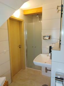 a bathroom with a shower and a sink at Hotel Daimerwirt in Moosinning