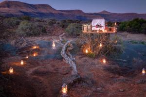 a view of a desert at night with lights at Samara Karoo Reserve in Graaff-Reinet +179 photos