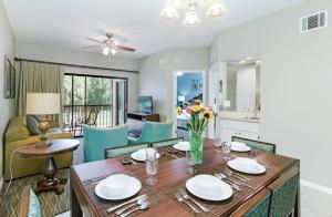 a dining room and living room with a table and chairs at Alhambra Villas in Kissimmee