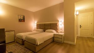 Postel nebo postele na pokoji v ubytování Royal Hill Hotel