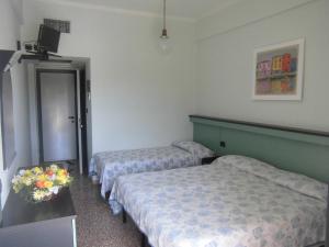 Postel nebo postele na pokoji v ubytování Hotel Palm Beach