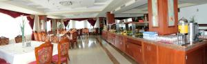 a restaurant with a bar with chairs and a counter at Hotel New Star in Skopje