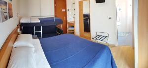 a hospital room with a bed with blue sheets at Hotel Mare Blu -- boutique in Pineto
