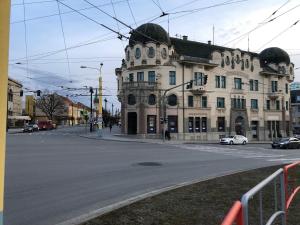 a large white building on a city street at Apartmán Lux Prešov in Prešov