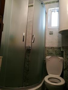 La salle de bains est pourvue d'une douche, de toilettes et d'une fenêtre. dans l'établissement Apartment Sinchets, à Varna