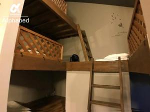 two bunk beds in a room with a ladder at Alphabed SunportTakamatsu 702 / Vacation STAY 21868 in Takamatsu