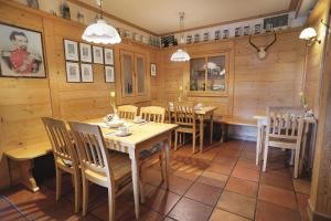a dining room with wooden walls and tables and chairs at Hotel Daimerwirt in Moosinning