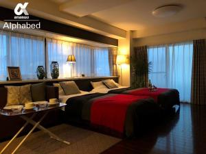 a hotel room with two beds and a table at Alphabed TakamatsuFurujinmachi 901 / Vacation STAY 21909 in Takamatsu