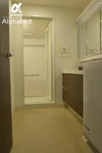 a bathroom with a walk in shower and a mirror at Alphabed TakamatsuFurujinmachi 901 / Vacation STAY 21909 in Takamatsu