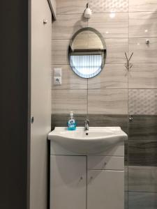 a bathroom with a sink and a mirror at Apartmán Lux Prešov in Prešov +14 photos