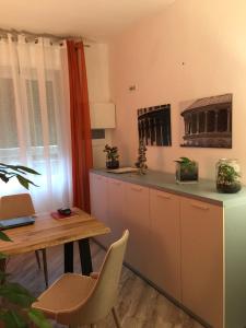 a kitchen with a table and a small table and a table and a tablektop at B&B Ariston Pisa Tower in Pisa