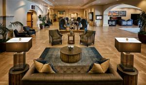 a lobby with a couch and tables and chairs at The Scottsdale Plaza Resort & Villas in Scottsdale