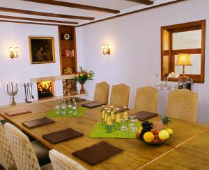 a dining room with a table and a fireplace at Hotel Kull von Schmidsfelden in Bad Herrenalb