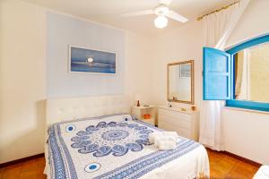 ジャルディーニ・ナクソスにあるCasa Azulのベッドルーム1室(ベッド1台、鏡、窓付)
