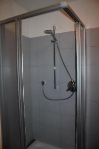 a shower in a bathroom with a glass door at Sterzingerhof in Vipiteno