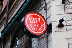 een rood-wit bord aan de zijkant van een gebouw bij City Backpackers Hostel in Stockholm