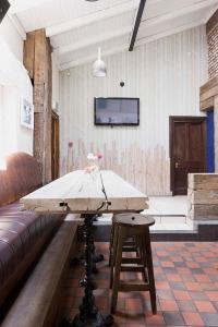 a table in a room with a couch and a tv at The Strand Inn in Dunmore East