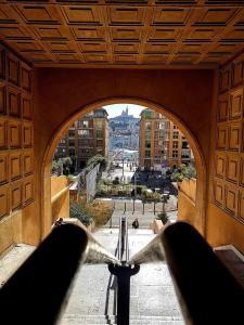 a view of a city from an archway in a building at Au coeur du Panier - Vieux Port in Marseille