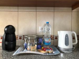 a kitchen counter with a coffee maker and a blender at Casa dos Morros in Lajes das Flores