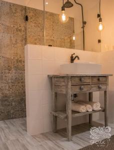 a bathroom with a sink and a mirror at Folk by Anne Apartments & Rooms in Warsaw