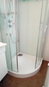 a shower with a glass enclosure in a bathroom at Chambres des Noels in Faye-dʼAnjou