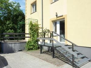 a metal staircase next to a building with a building at Hotelik Na Zdrowiu in Łódź