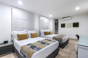 Postel nebo postele na pokoji v ubytování Hotel Madeiro