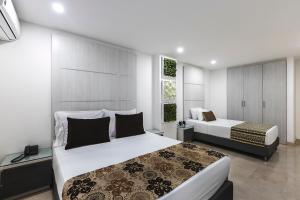 Postel nebo postele na pokoji v ubytování Hotel Madeiro