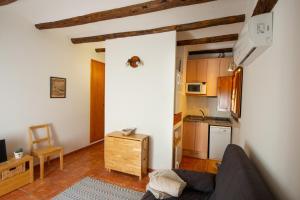 a living room with a couch and a kitchen at Apartamentos Aguilar in Alcañiz