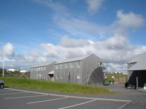 a group of buildings in a parking lot at Lava Hostel in Hafnarfjörður