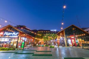 a city street at night with lights and buildings at Icon Park Hotel, Chiang Mai in Chiang Mai