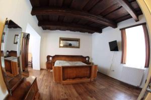 a bedroom with a bed and a large window at Penzion Bohemia in České Budějovice