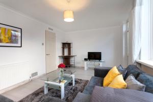 a living room with a couch and a table at Shell in Loughborough