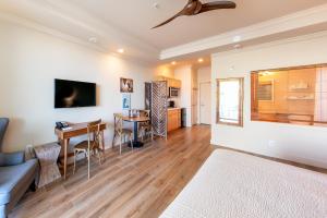 a living room filled with furniture and a kitchen at Lime Tree Bay Resort in Islamorada