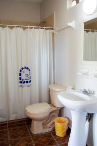 a bathroom with a toilet and a sink at Hotel Hacienda Vallarta - Playa Las Glorias in Puerto Vallarta