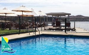 a swimming pool with a water slide in it at Cabañas La Puntilla Lago Rapel in Lago Rapel +60 photos