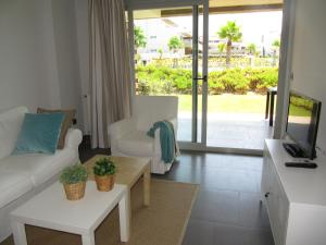 a living room with a couch and a tv at Life Apartments El Rompido in El Rompido