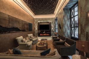 a living room with couches and a fireplace at Hotel Casa Palacio María Luisa in Jerez de la Frontera