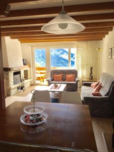 a living room with a table and a couch at Clabina 31 in Leukerbad