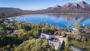 an aerial view of a lake with boats in it at Freycinet Cottage 1 – Bluestone in Coles Bay