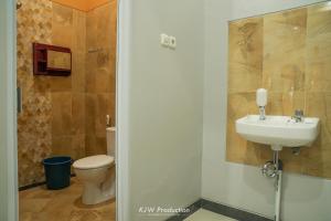 a bathroom with a sink and a toilet at M Stay Guest House Jogja in Yogyakarta