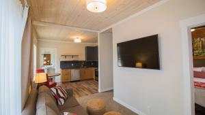 a living room with a couch and a flat screen tv at Cranberry Arms Pub and Hotel in Nanaimo